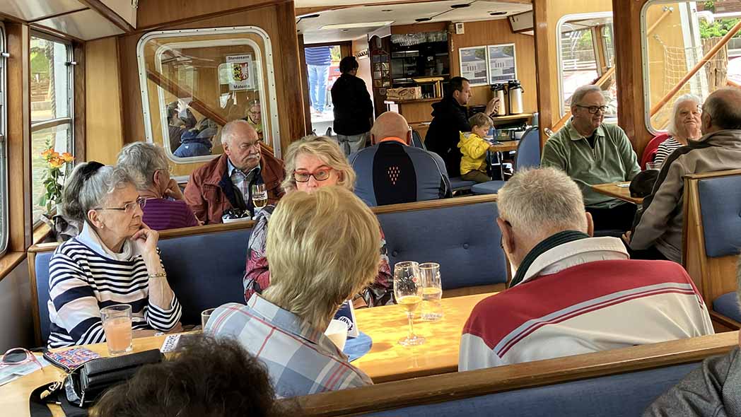 Menschen sitzen am Tisch im Schiff
